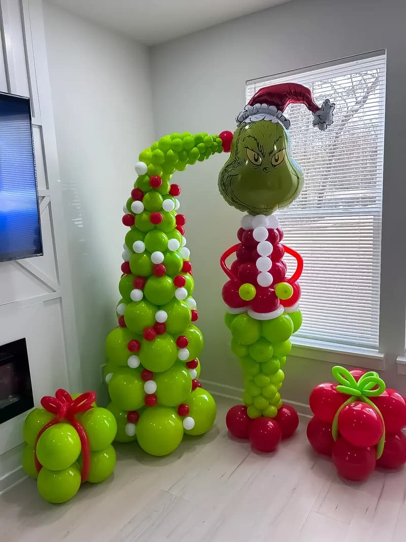 Grinch balloon sculpture with balloon Christmas presents