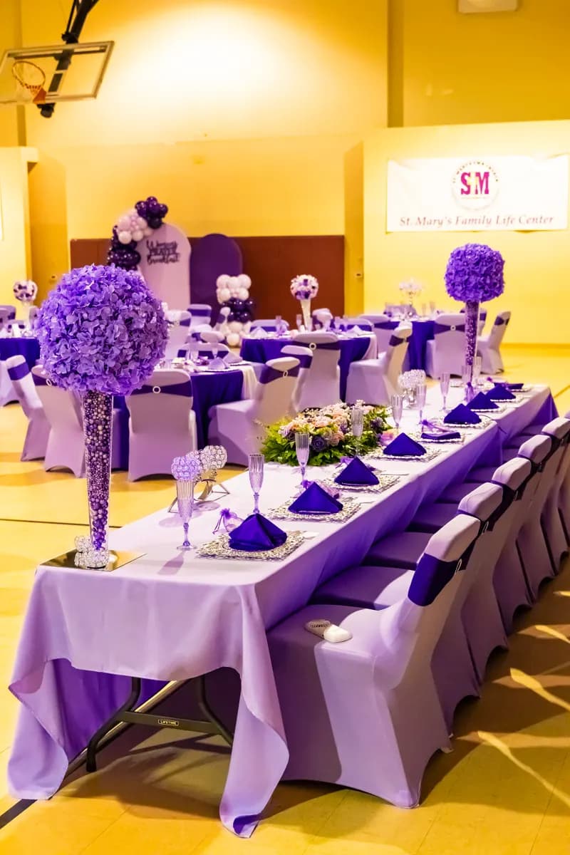 Head table in lavender and purple with hydrangea tower centerpieces